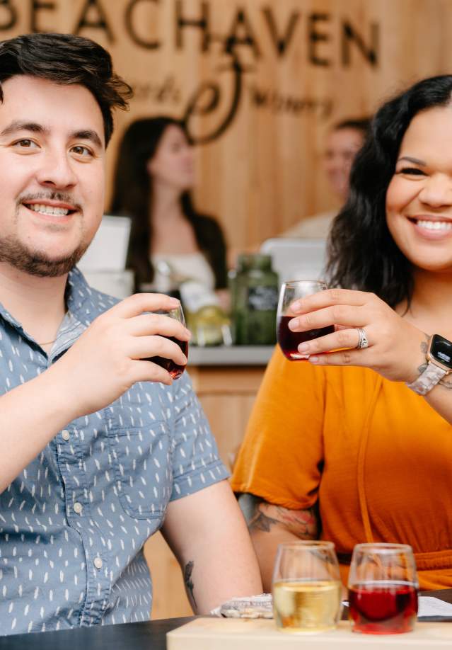 a couple enjoying samples of wine and playing table games