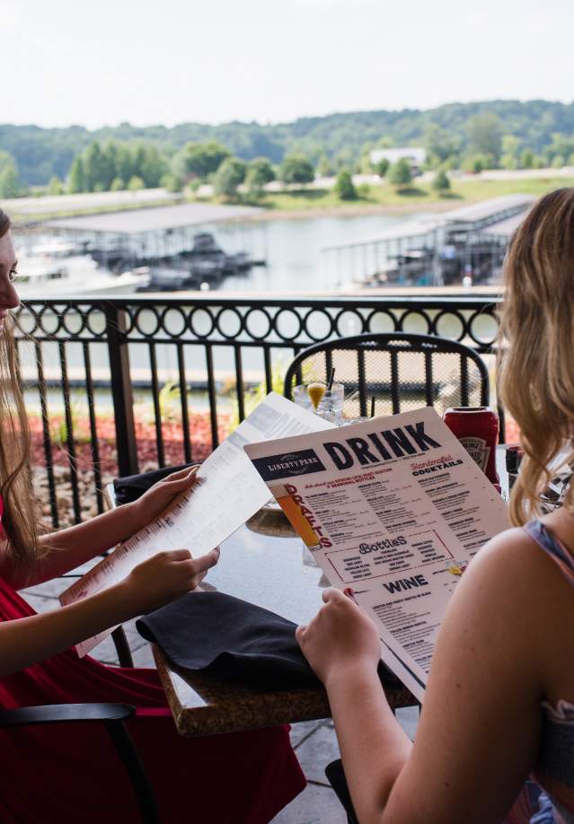two ladies dining overlooking a marina