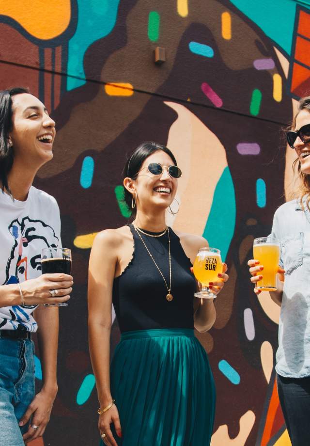 Group of girlfriends enjoying a glass of beer at a local craft brewery
