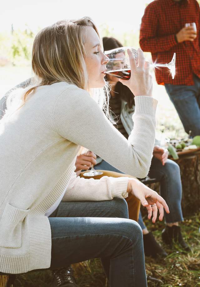 Group of friends enjoying a glass of wine at an outdoor event