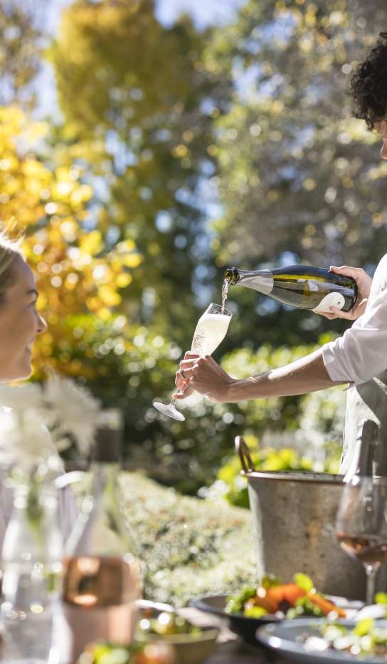 Waitress pouring champaign for guest