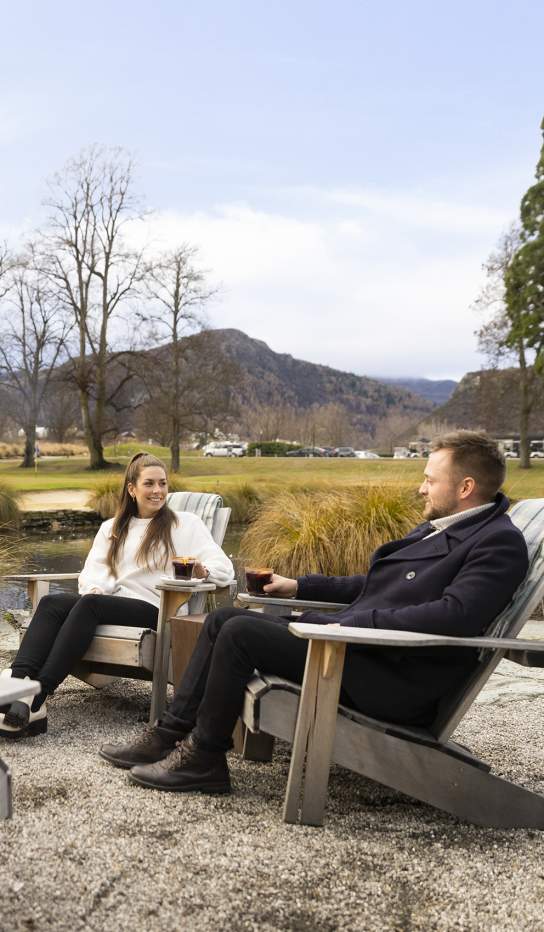 People enjoying at mulled wine by an outdoor fire at Smithy's Smoke House, Millbrook Resort