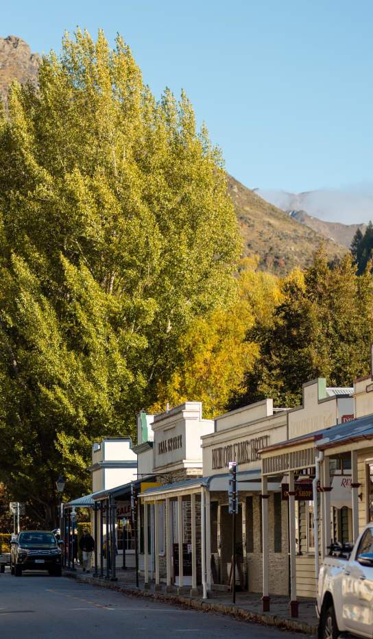Street lined with old buildings and boutique shops in Arrowtown
