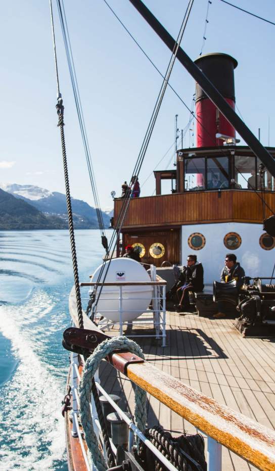 TSS Earnslaw Vintage Steamship Cruise on blue lake with snow covered mountains
