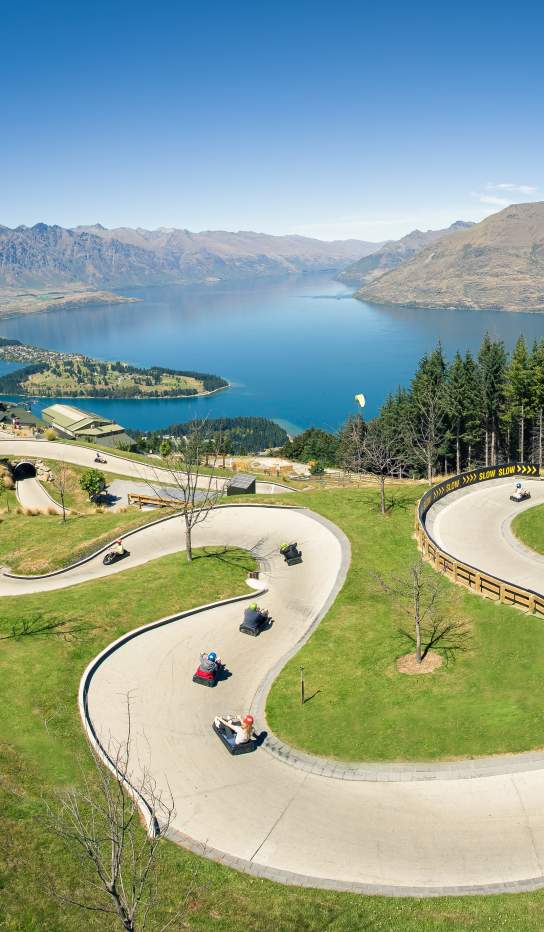 People on the Skyline Queenstown luge with elevated views of Queenstown