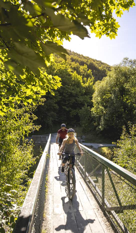 Cyclists biking in Arrowtown during summer