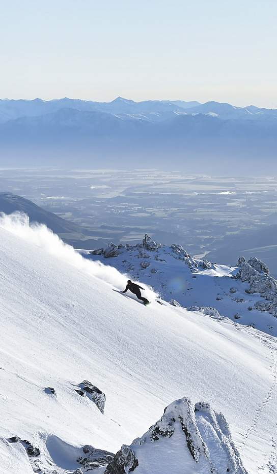 Snowboarder off psite at Cardrona Alpine Resort