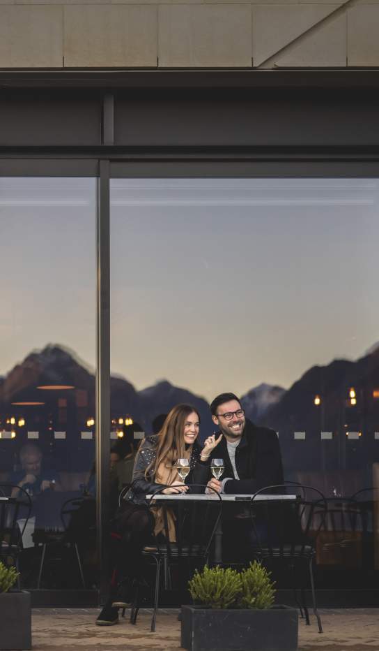 Two people dining out front of The Grille by Eichardt's Restaurant
