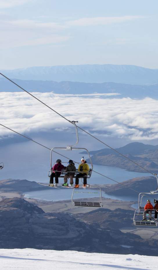 People riding the chairlift at Treble Cone Ski Field, Wānaka