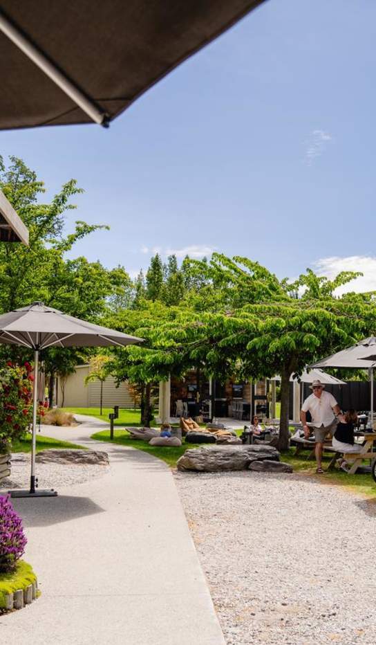 Shot of Kinross Winery & Bistro outdoor courtyard on a sunny day with people dining