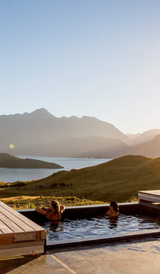 Two women relaxing in the outdoor spa at Aro Ha Wellness Retreat