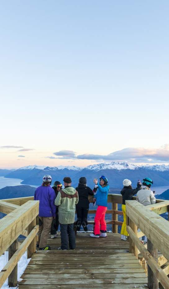 Group of people sightseeing at viewpoint atop of a mountain
