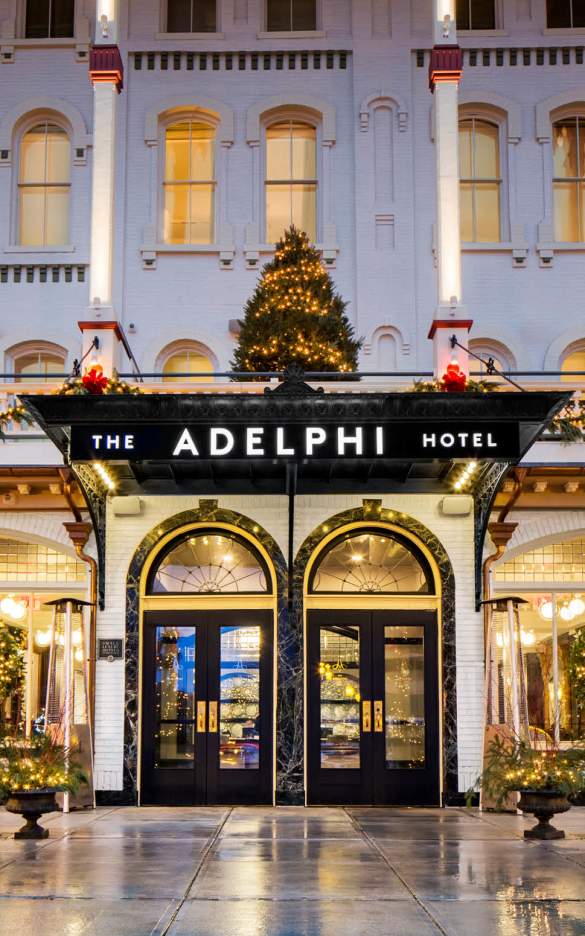 Front of the Adelphi with tiny white lights, decorated lamp posts, wreaths and tree