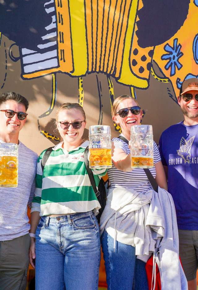 5 friends holding up beer steins at TosaFest