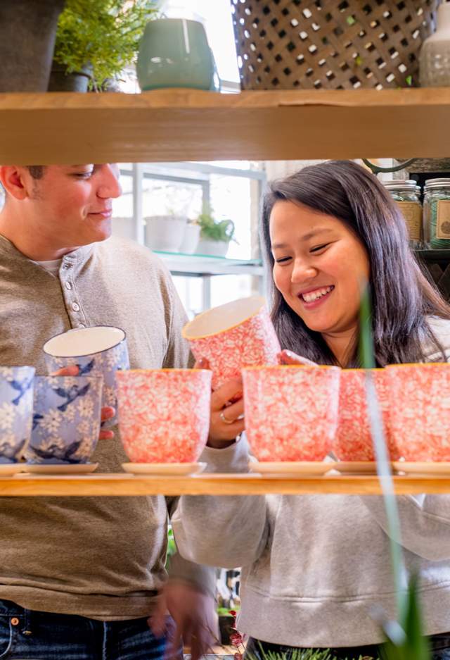 couple looking at colorful plant pots