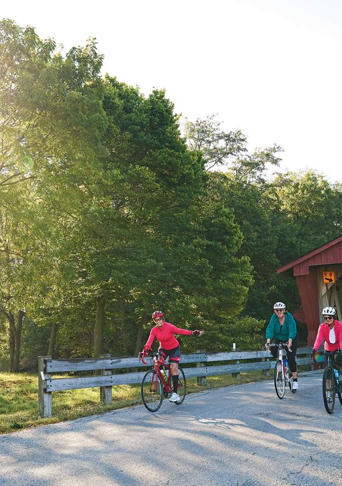 Bicycling in front of Spain Creek Covered Bridge