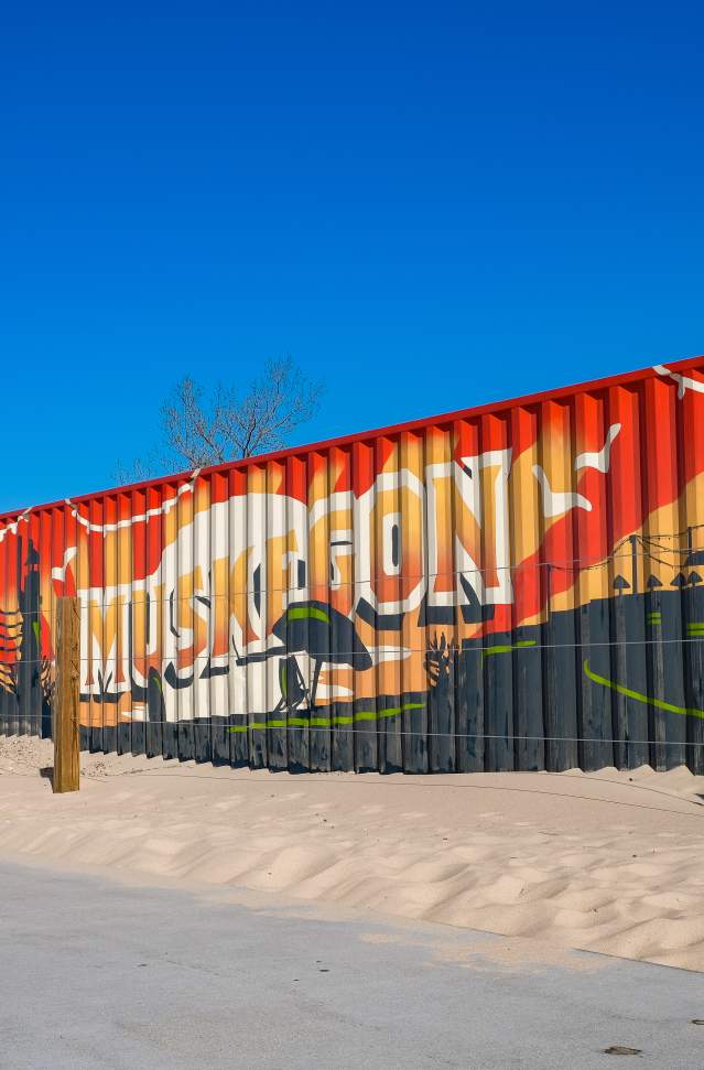 muskegon mural painted on shipping container serving as stage on beach