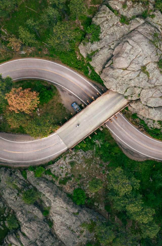 Drone shot above the pigtail and mountain tunnel of iron mountain road in the black hills