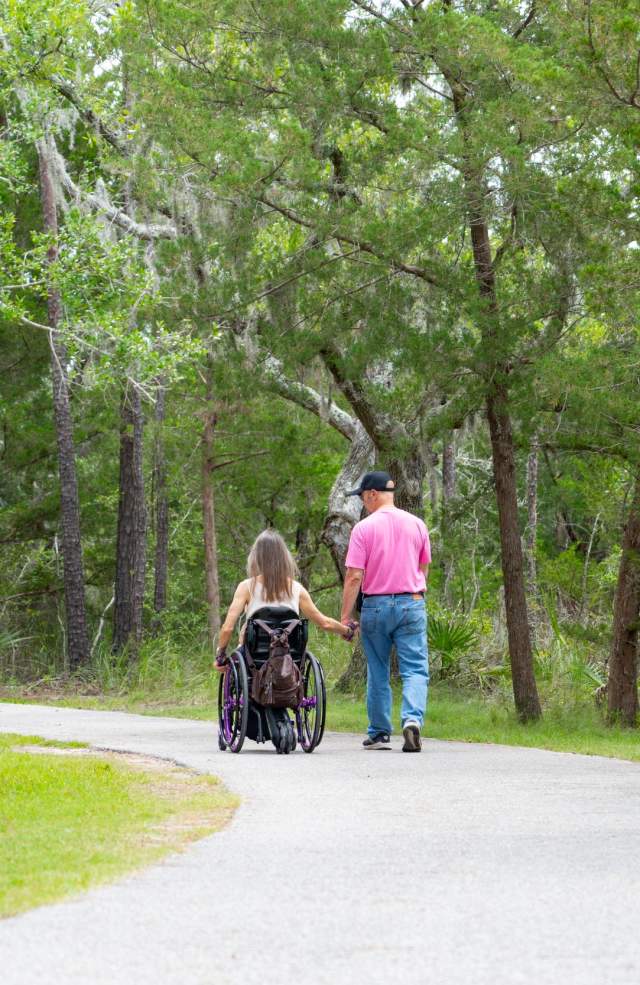 Two people on a paved park trail