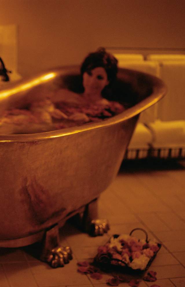 A couple in a spa tub lounging romantically