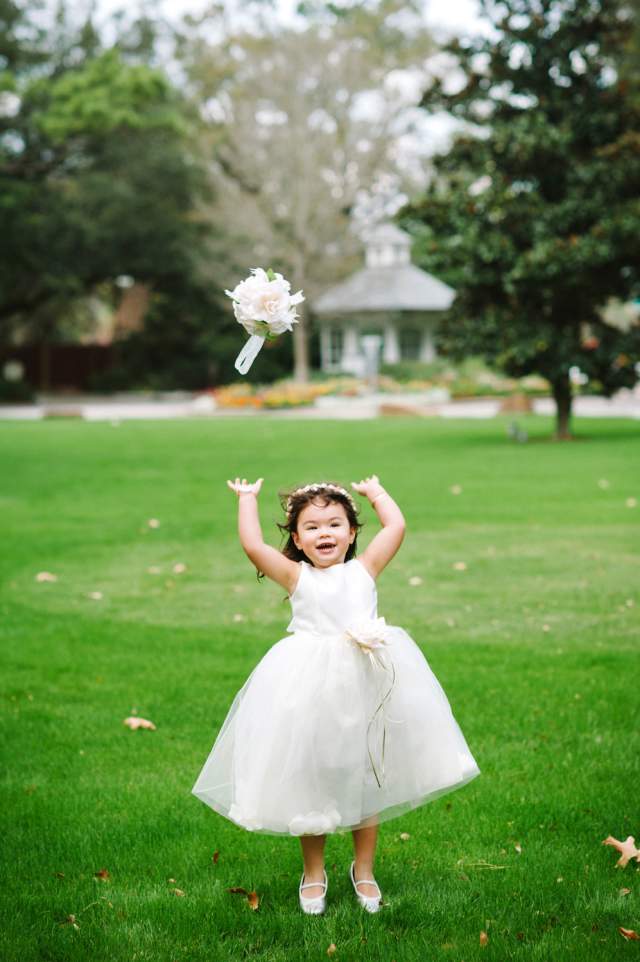 Wedding flower girl throws bouquet