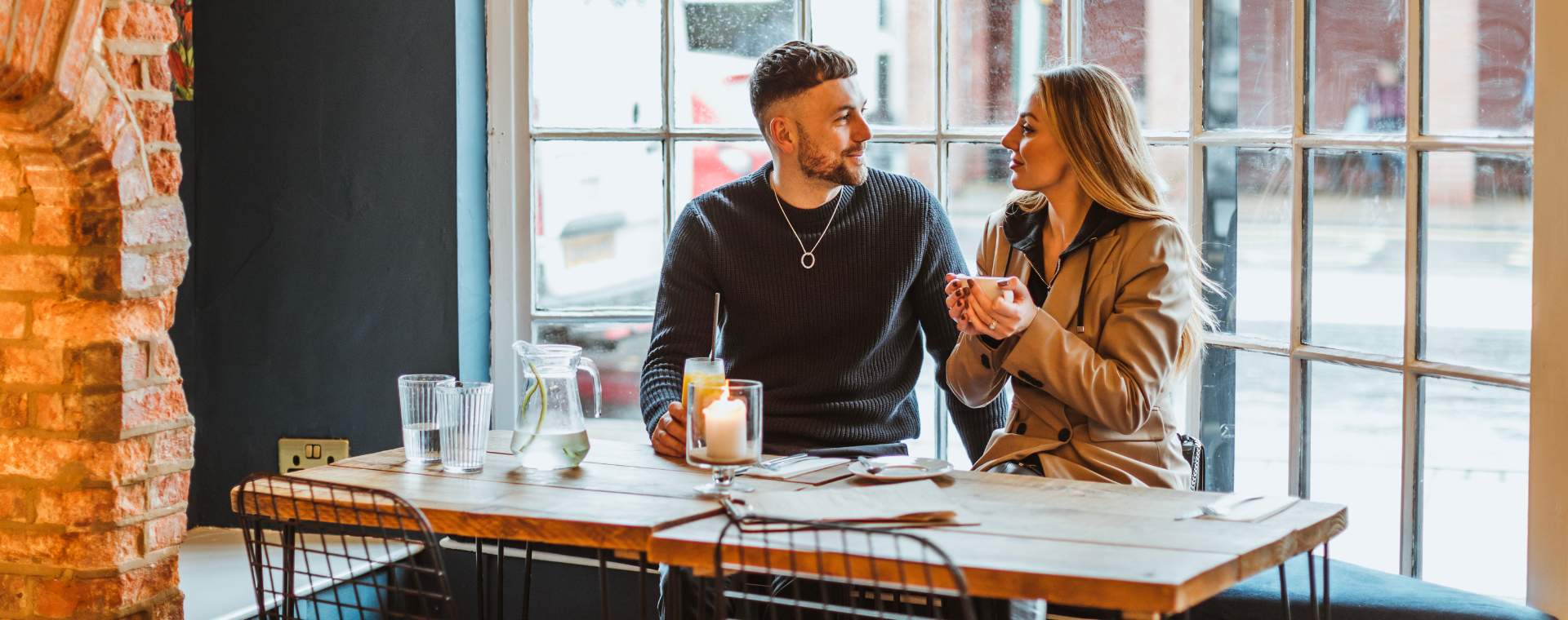 A couple enjoying a coffee in a Cottingham Cafe.