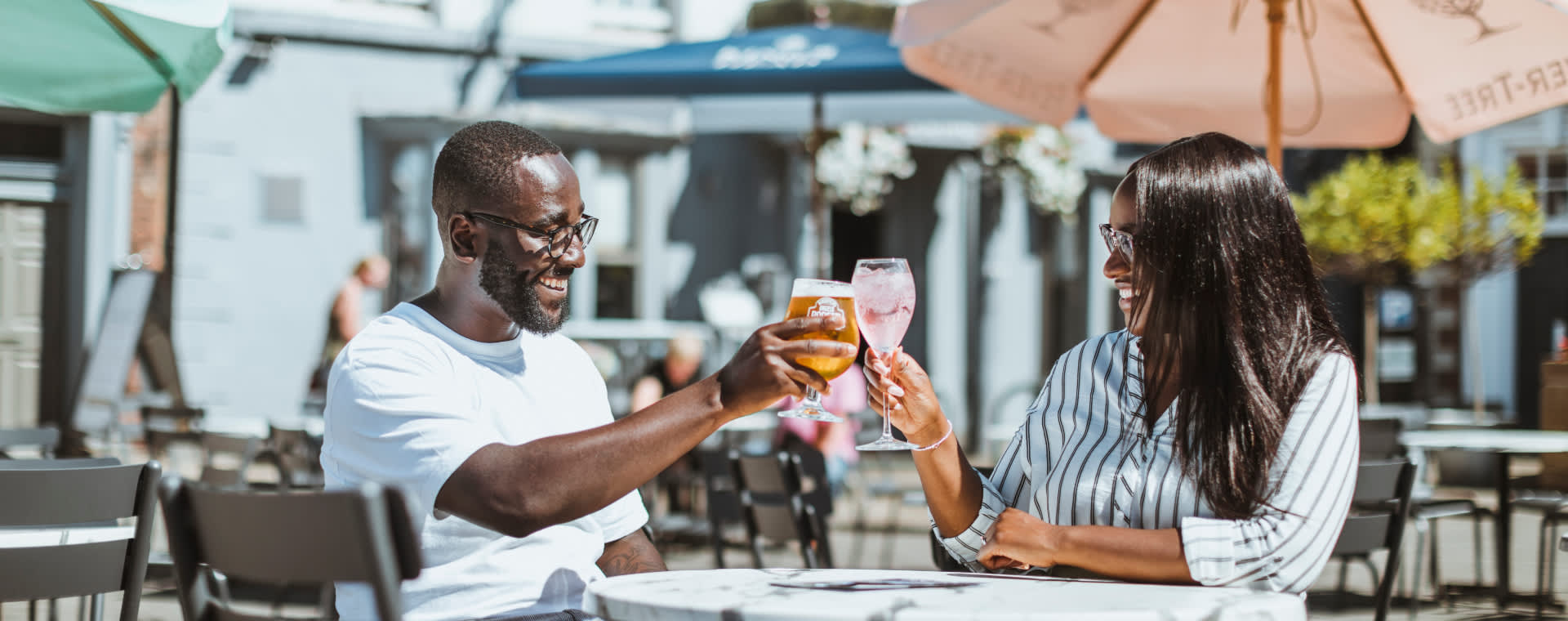 Couple having a drink outside at the Kings Head pub in Beverley, East Yorkshire