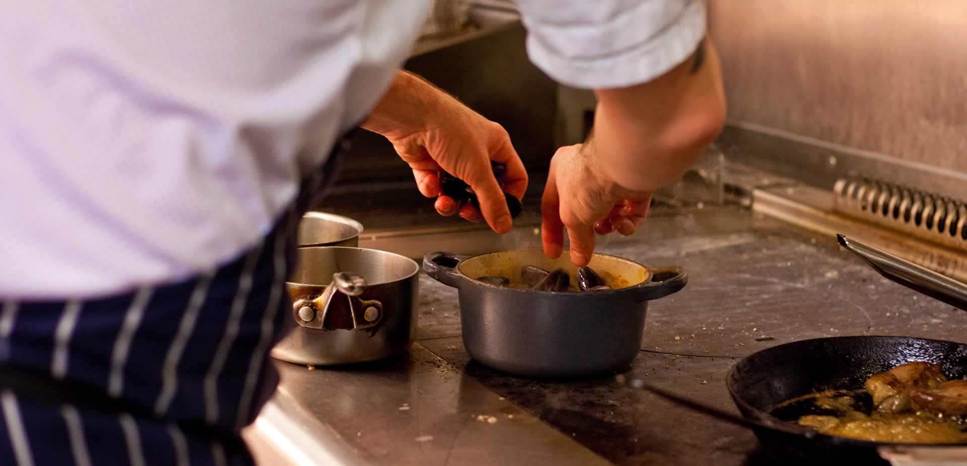 A chef at ABar Bistro in Portsmouth prepares a meal