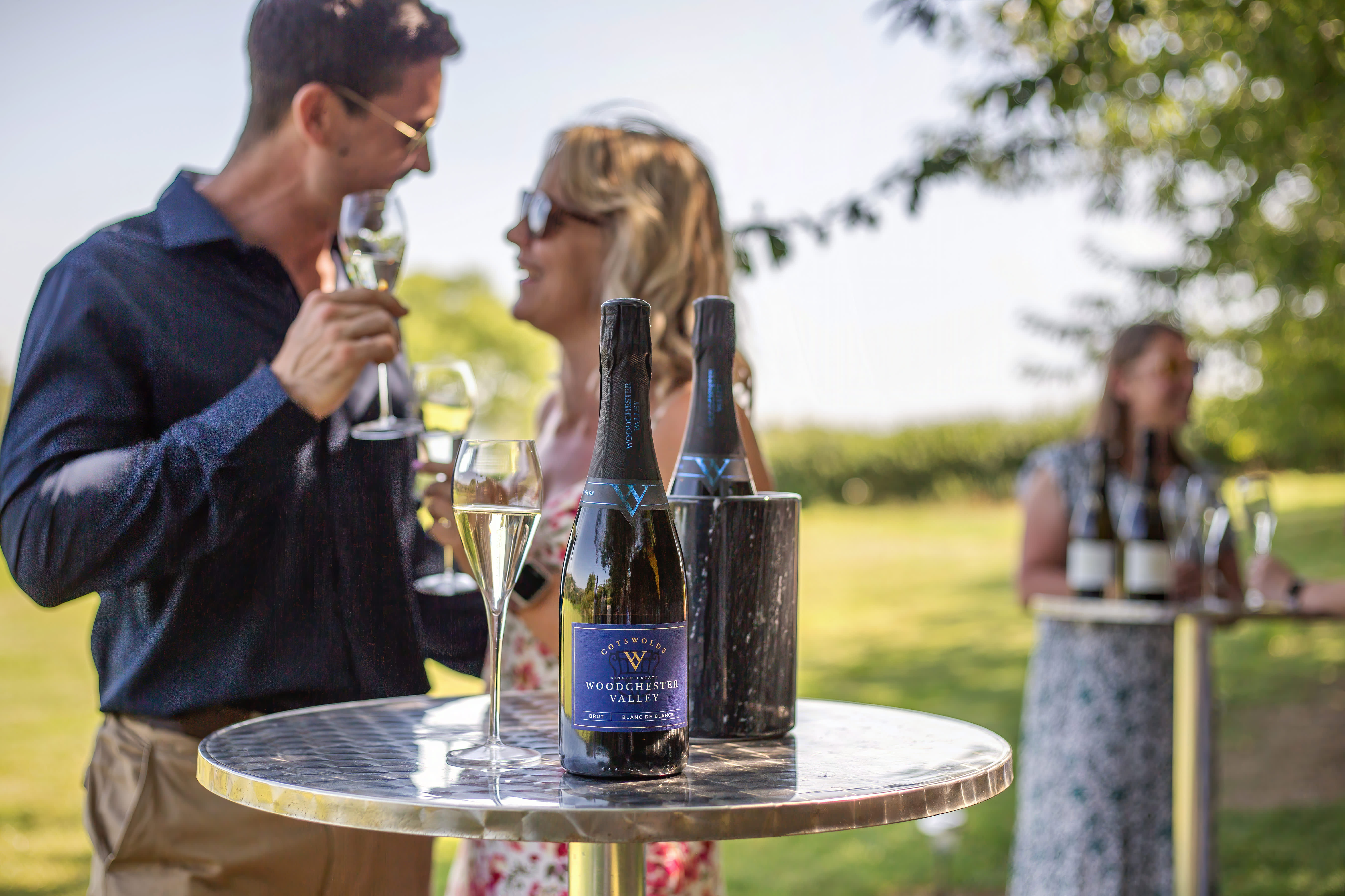 A couple enjoying a glass of wine at Woodchester Valley Vineyard