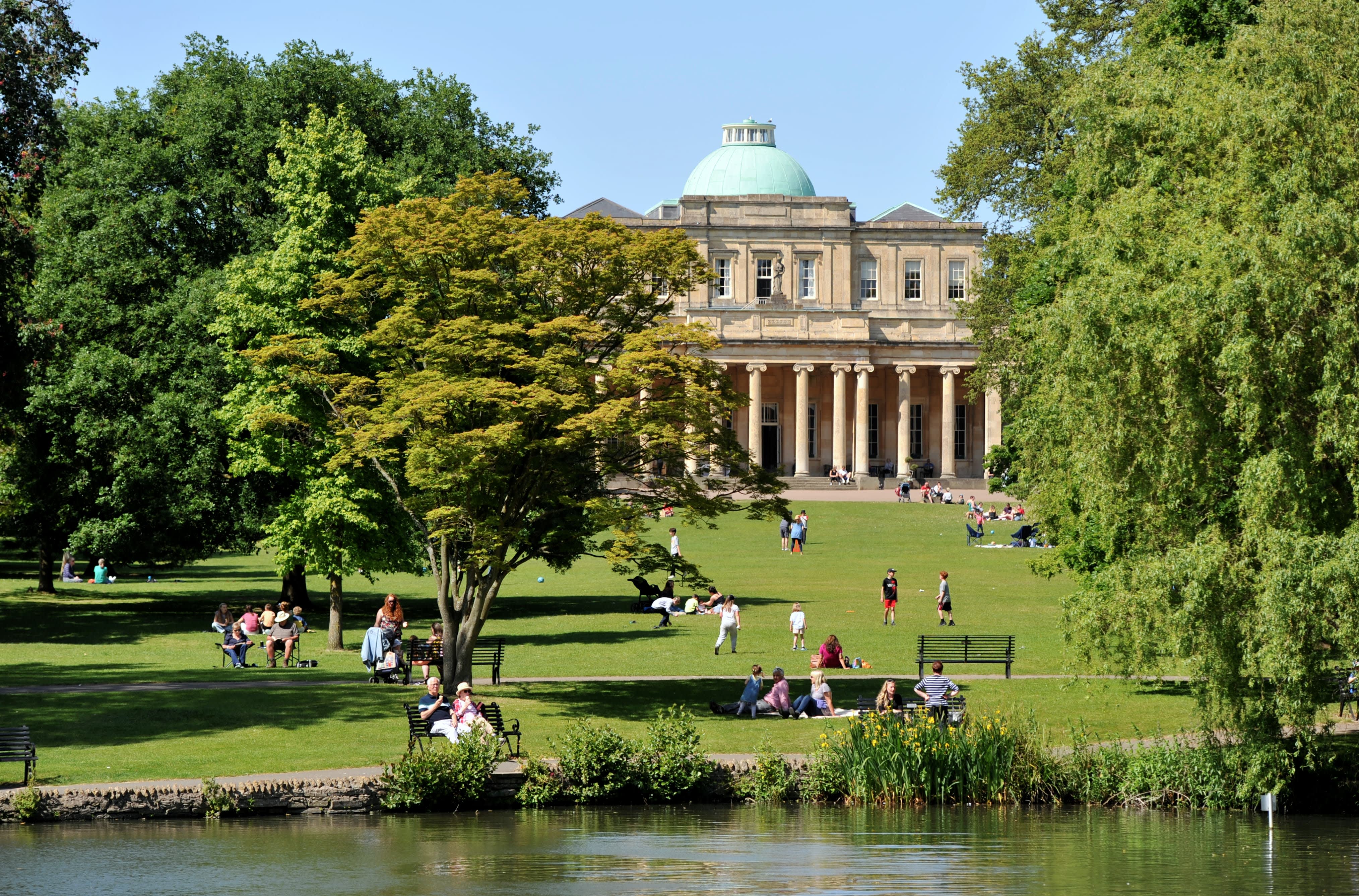 People enjoying the sunshine at Pittville Park Cheltenham in the summer.