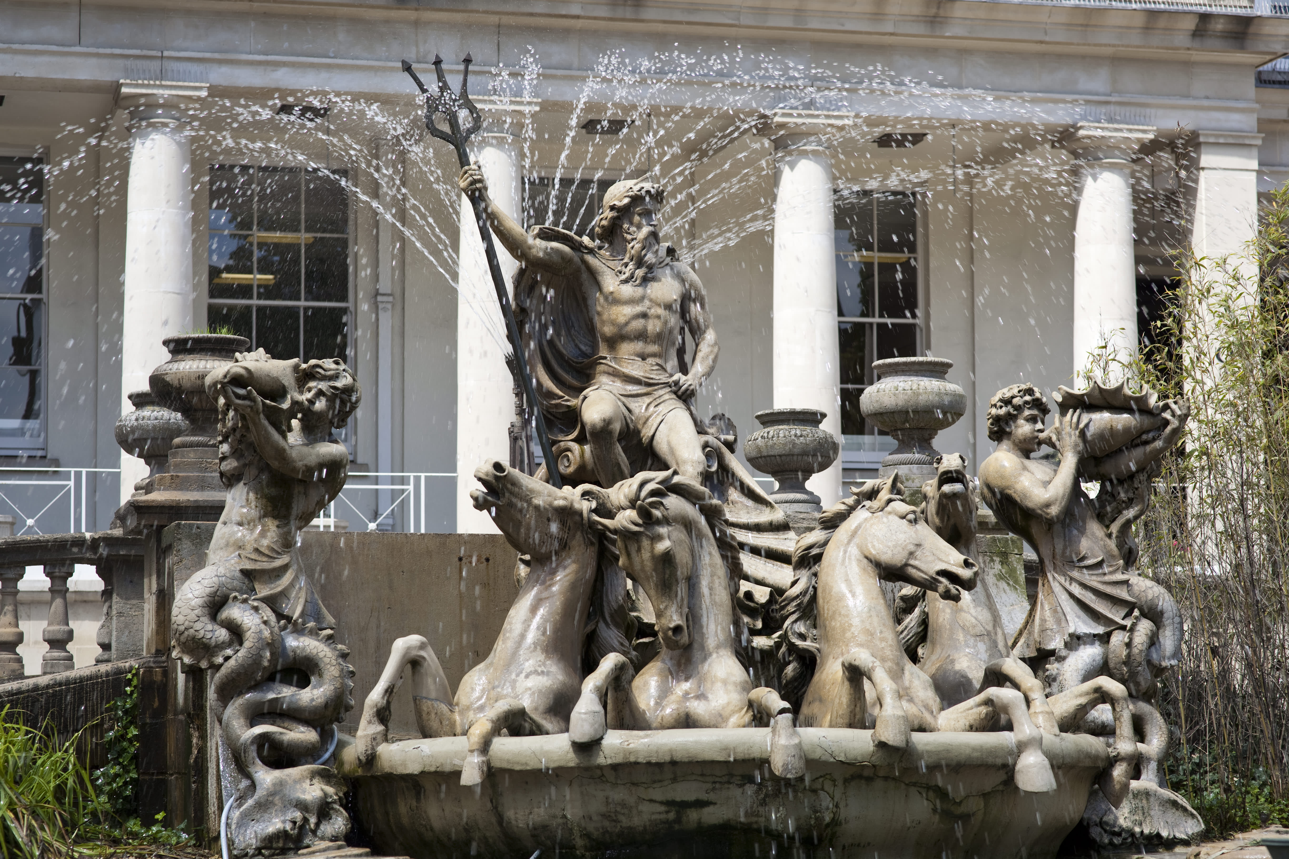 A large fountain depicting Neptune in a chariot drawn by four seahorses, accompanied by a merman blowing a conch shell