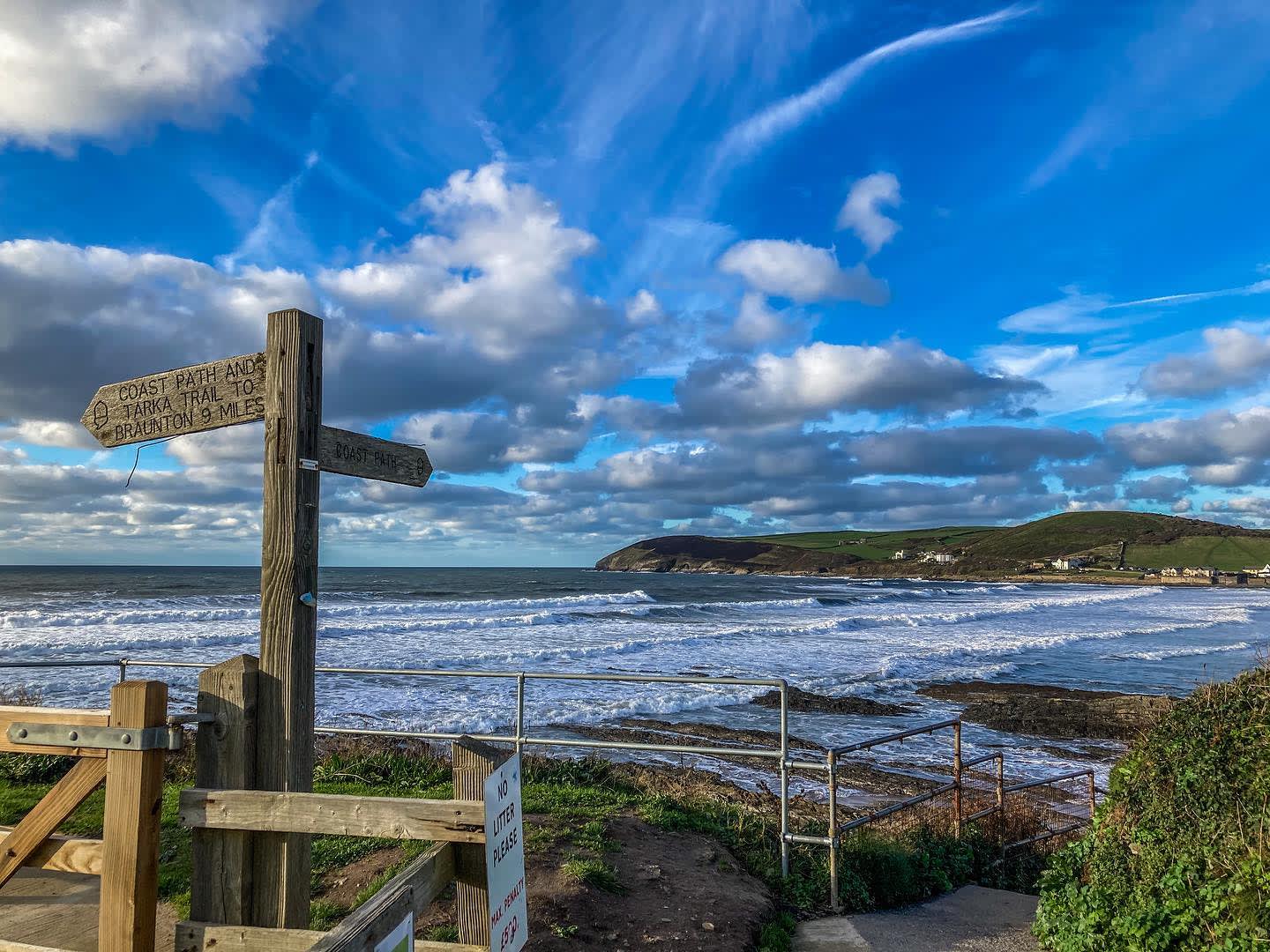 View of Croyde Bay with coastal path signs