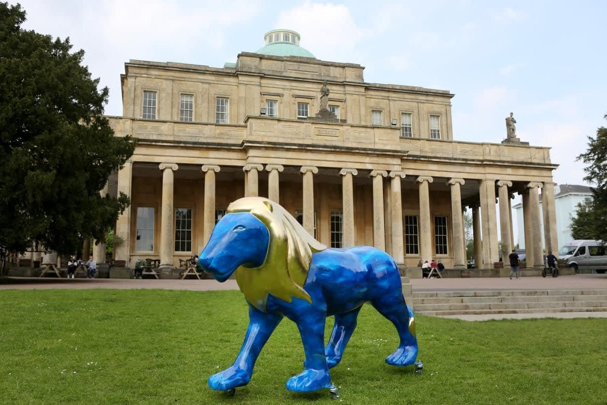 Large Lions at Large sculpture stood outside Pittville Pump Room, Cheltenham.