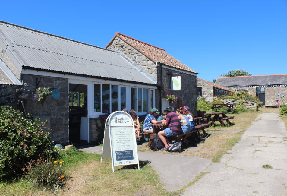 People eating outside The Island Bakery on St. Martin's