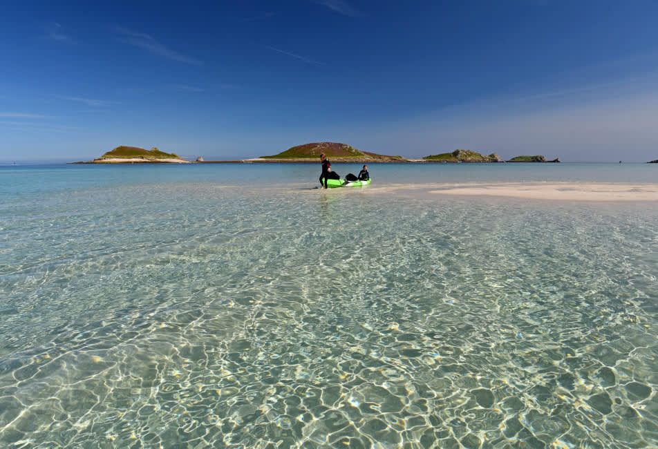 Couple on a sand bar with a kayak