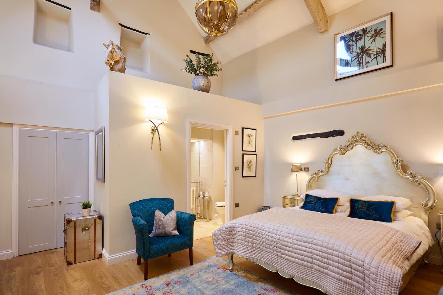A vaulted ceiling bedroom with an ornate king-sized bed