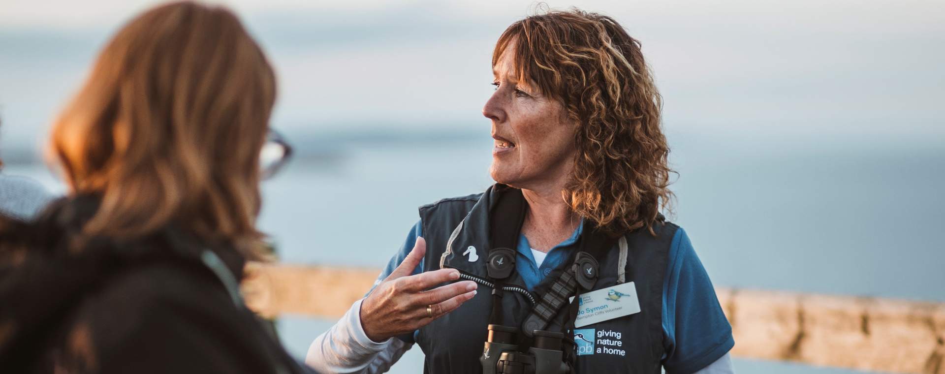 A tour guide answering questions at RSPB Bempton Cliffs