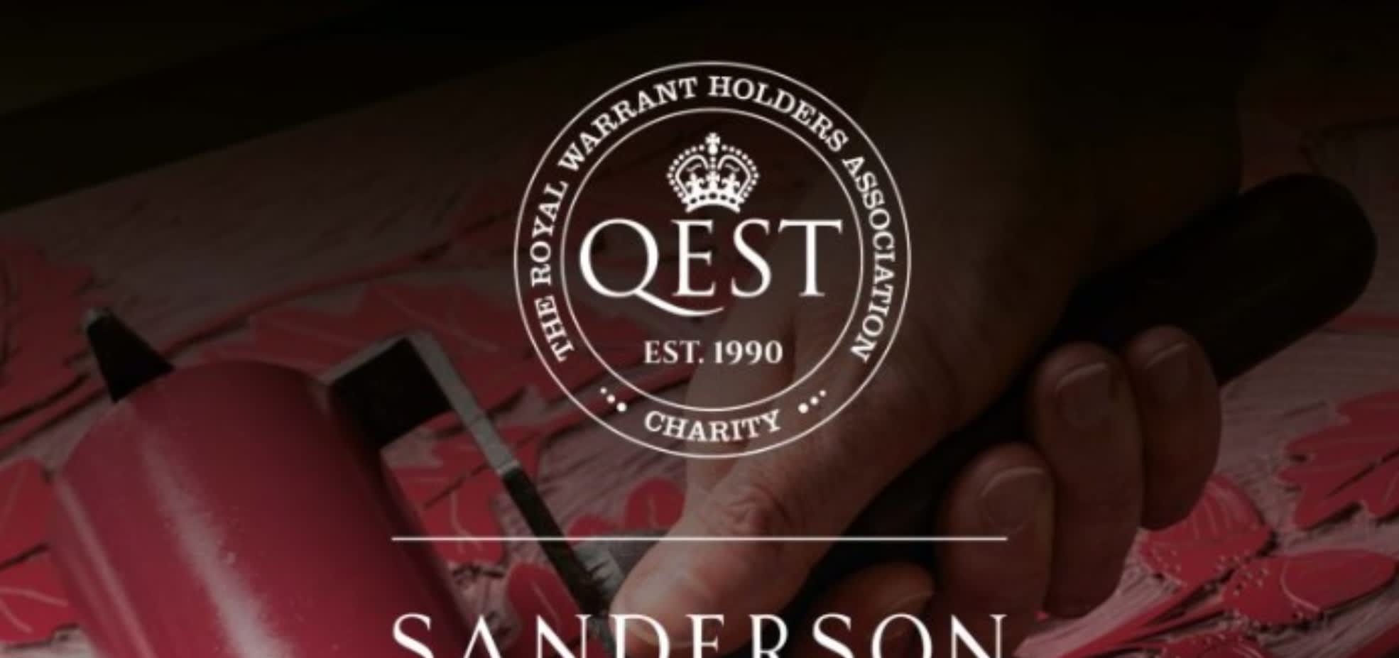 QEST logo. A white crest outline with white text and a white crown. The background is a dimmed image of a hand using a paint roller on a print press. The paint is red.