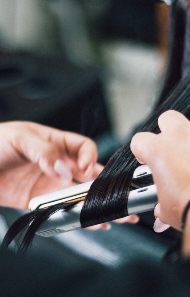 A close up shot of hair being styled at a salon