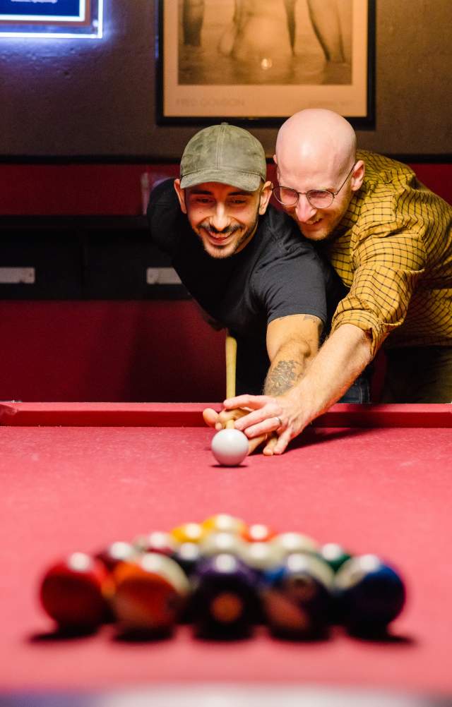 Couple Playing Pool at Bar