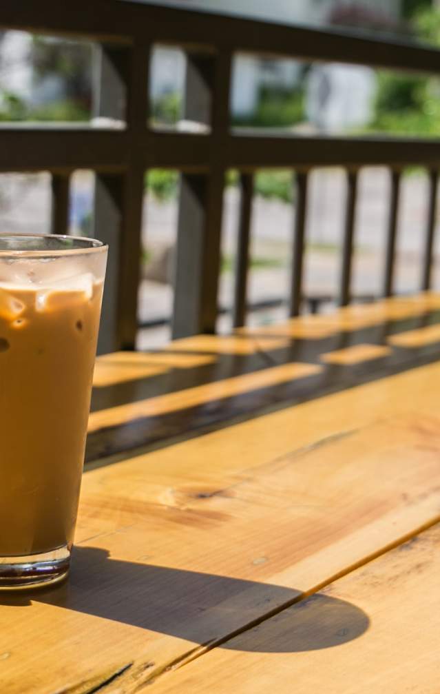 Two people enjoying iced coffee from Hopscotch Coffee