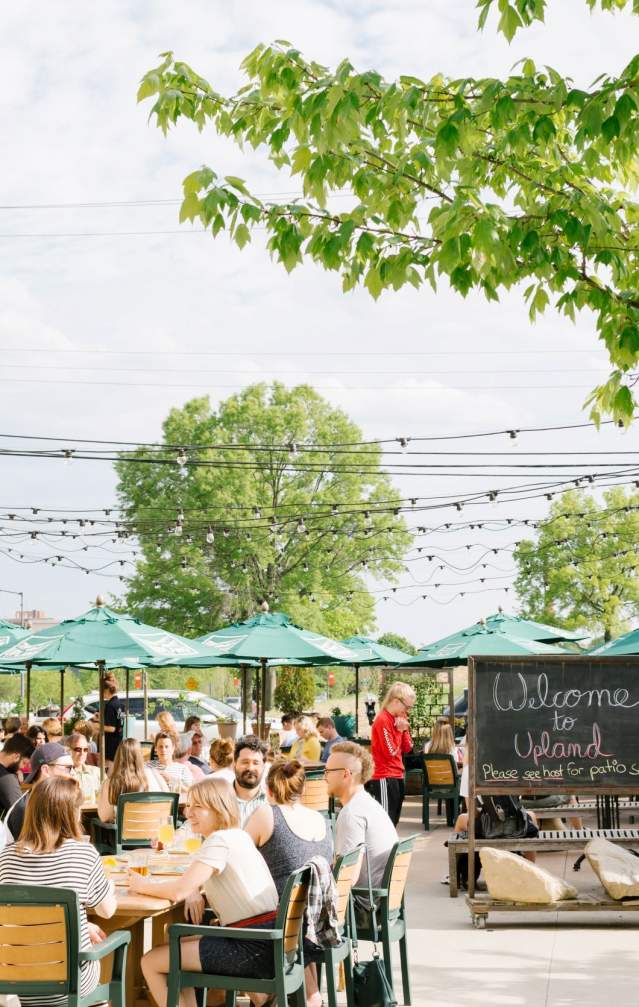 People dining on the patio at Upland