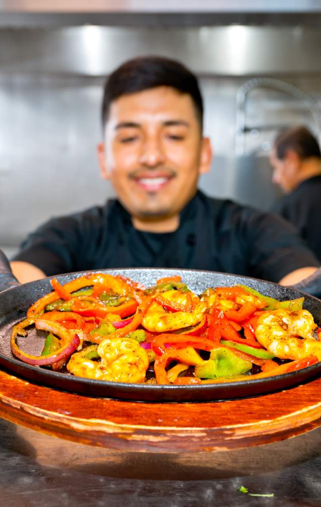 Man holding plate of delicious looking Mexican Food