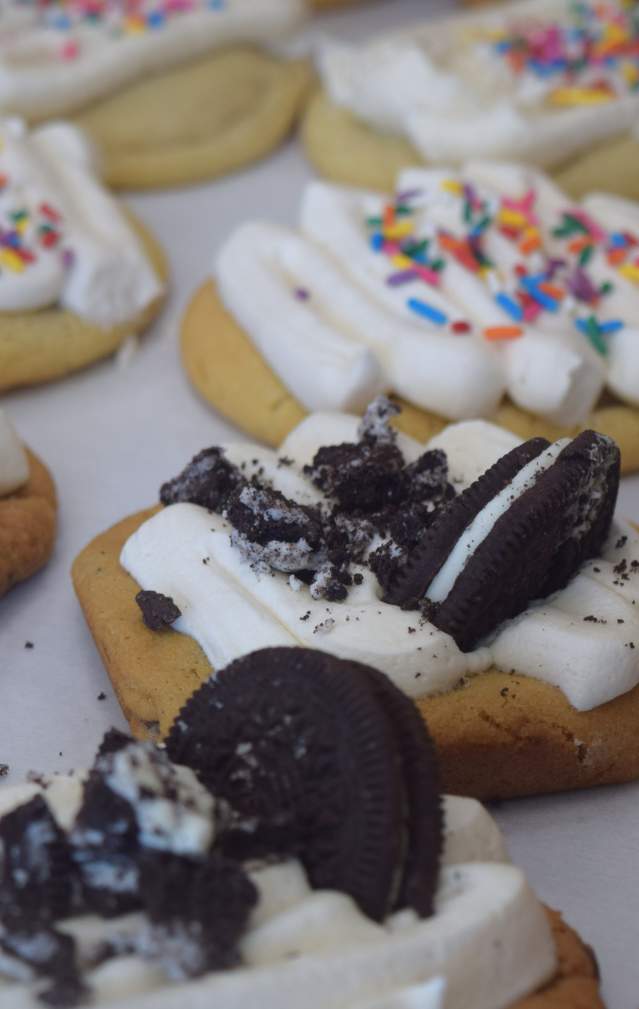 Freshly decorated cookies in the display window of a cookie and ice cream shop.