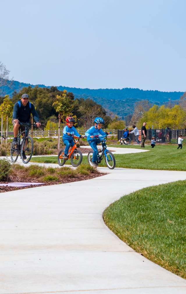 Man and 2 children riding bikes