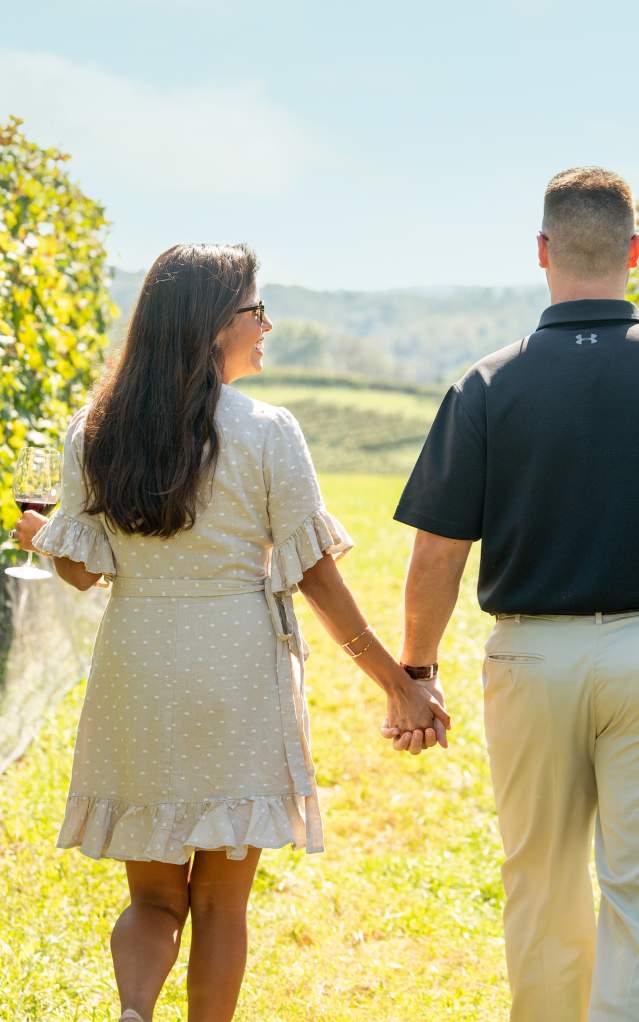 Couples Walk Through the Vines
