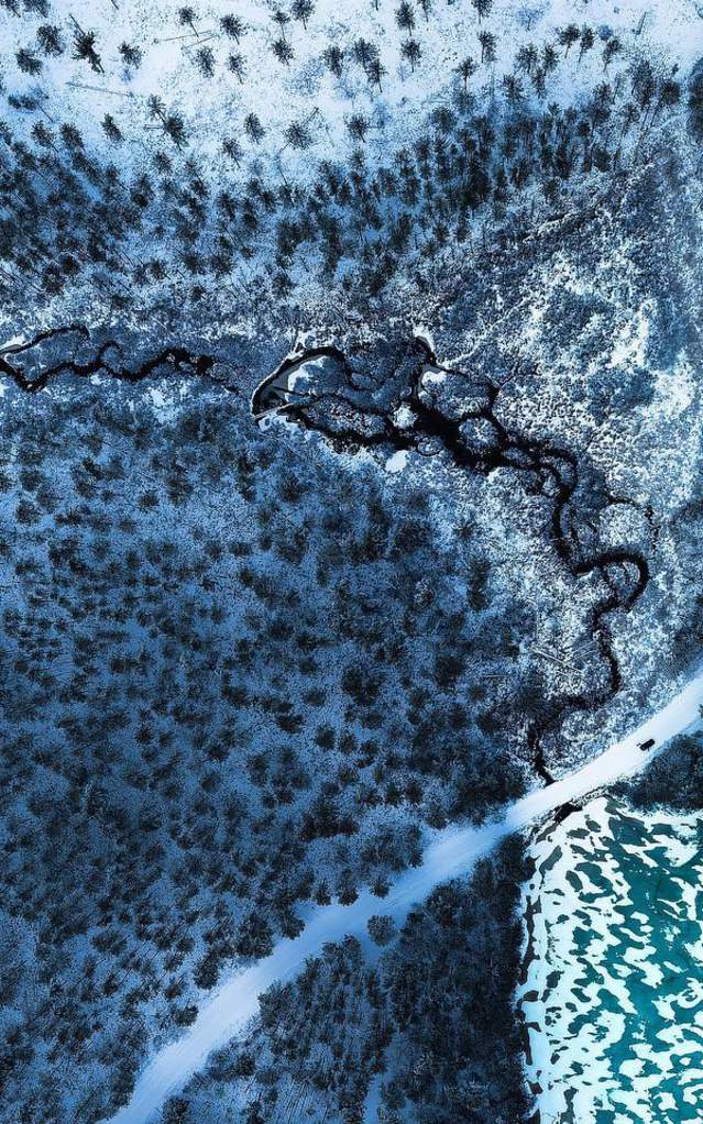 an aerial shot of a winter landscape