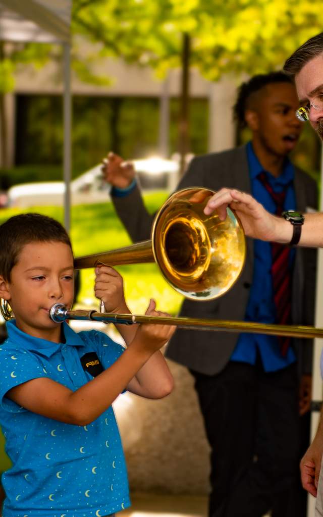 Boy playing trombone at Taste of the Arts