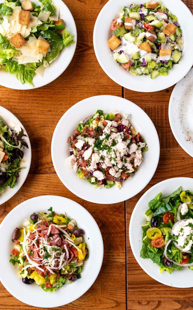 A full table of Italian food, including Pizza, salad, appetizers, and dessert. At Giordano's in Fort Wayne