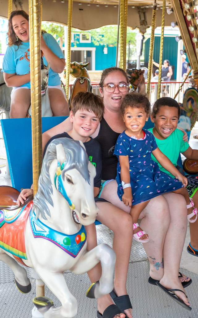 Family riding on carousel